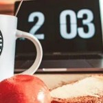 closeup photo of white and black printed ceramic mug beside pastry